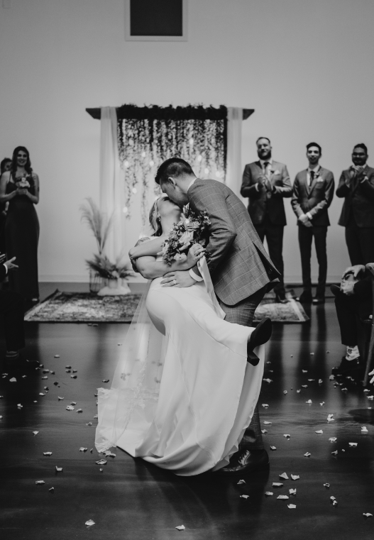 Connell dipping Danielle while walking down the aisle after getting married.
